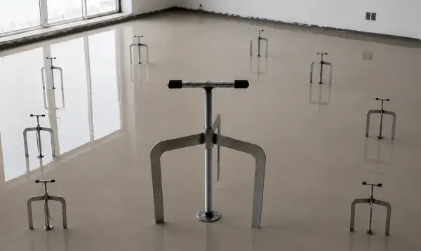 adjustable floor leveler jacks standing on wet self leveling floor